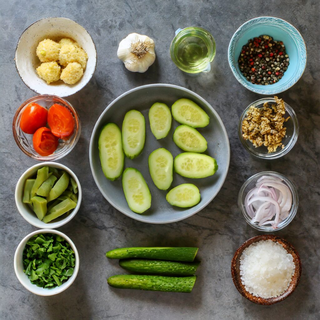 A flat lay image of all the key ingredients for making keto fried pickles, neatly organized on a kitchen counter.
