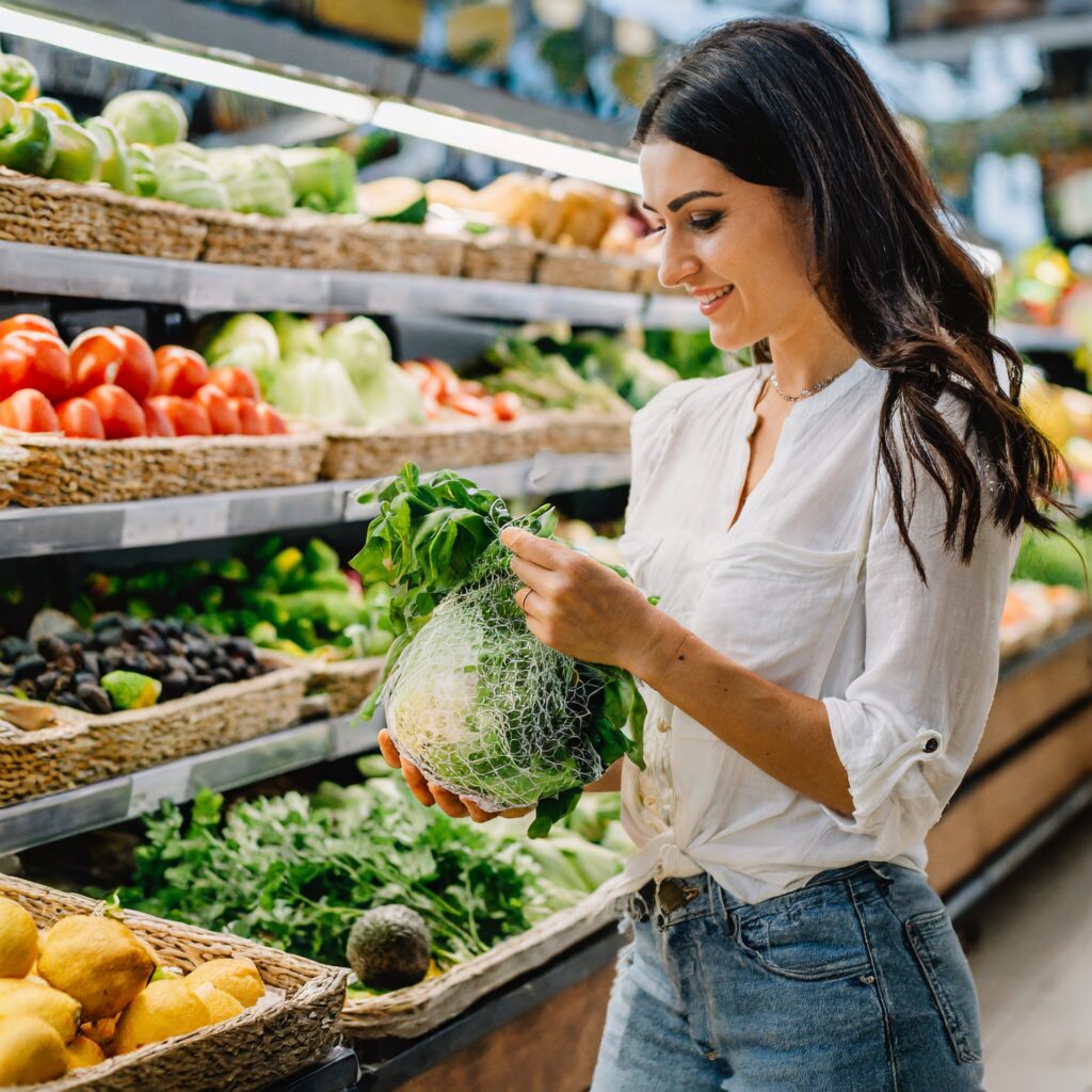 An image of a person shopping for fresh, organic ingredients in a grocery store, emphasizing the importance of sourcing high-quality components for keto salad dressings.